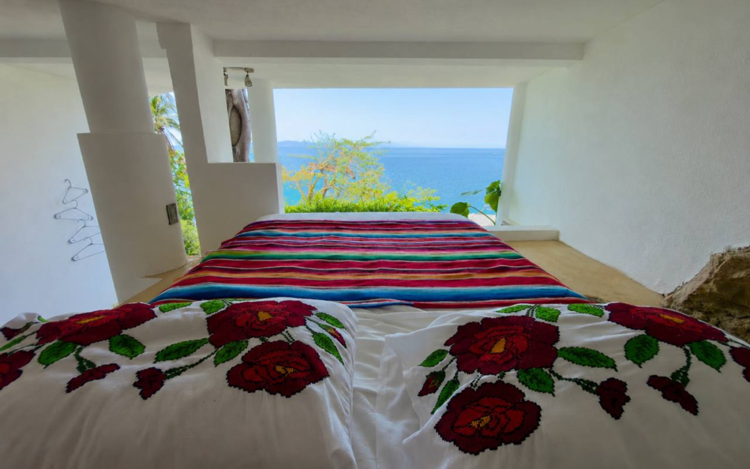 Room 14 – Lofted Queen Ocean Room bed with open ocean view