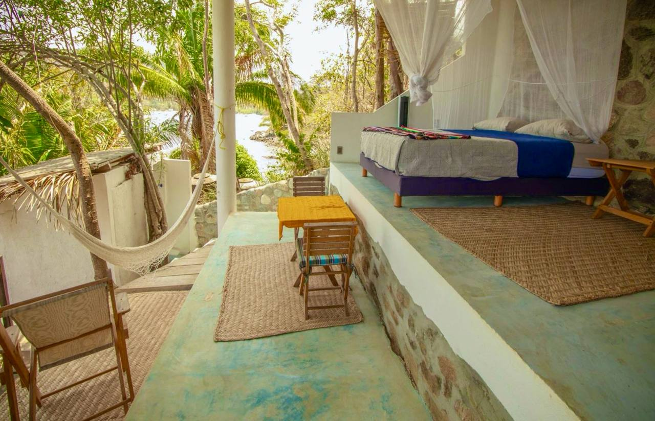 Room 2 open-air ocean queen with hammock, queen bed, and ocean view